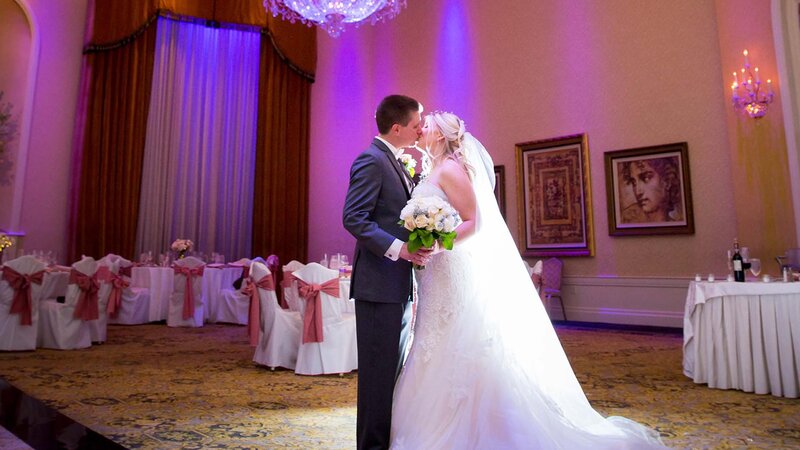 Bride & Groom kissing in ball room.