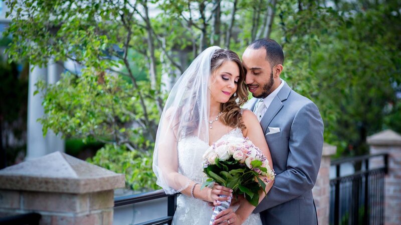 Bride & Groom looking at flower bouquet