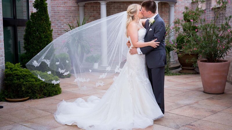 Bride & Groom kissing outdoors.