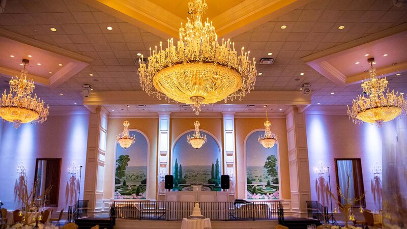 Elevated stage in ballroom with DJ setup.